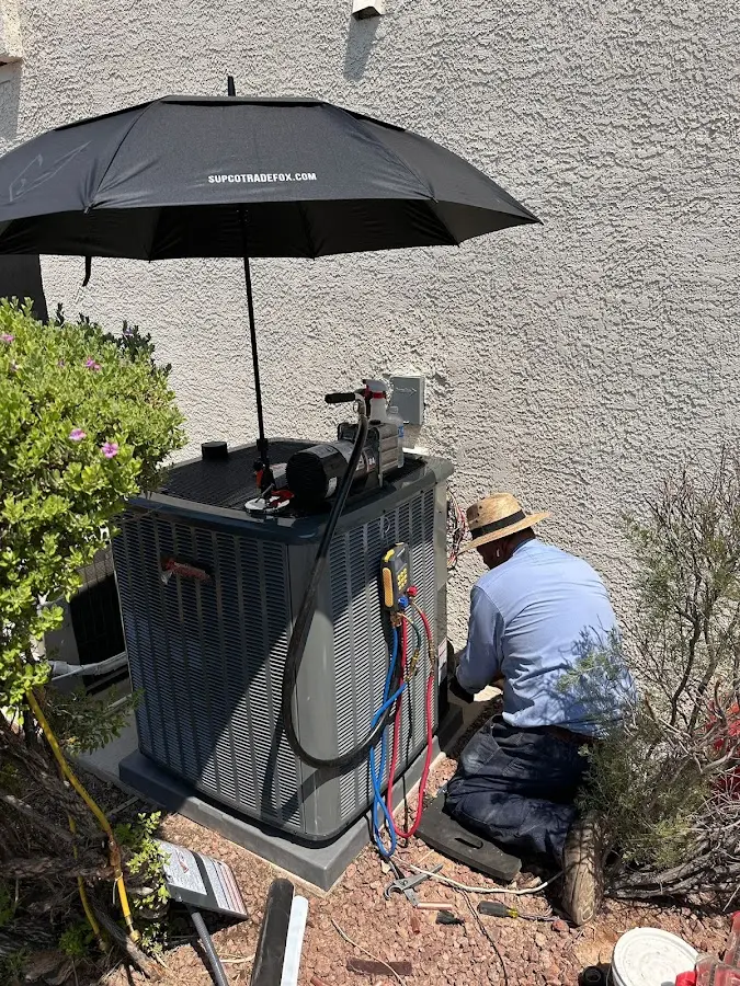 HVAC technician performing outdoor AC maintenance in Palmyra